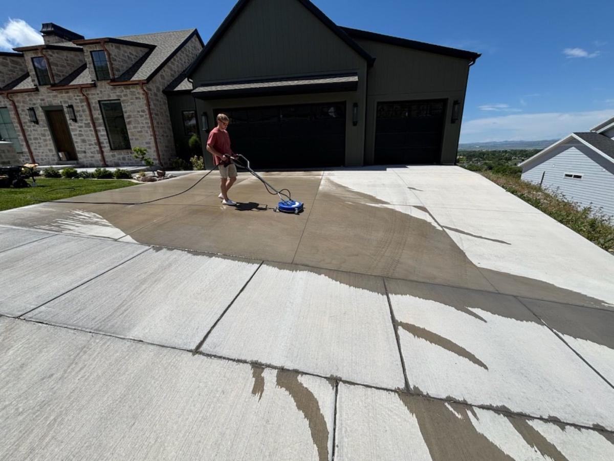 Pressure washing a residential driveway before sealing